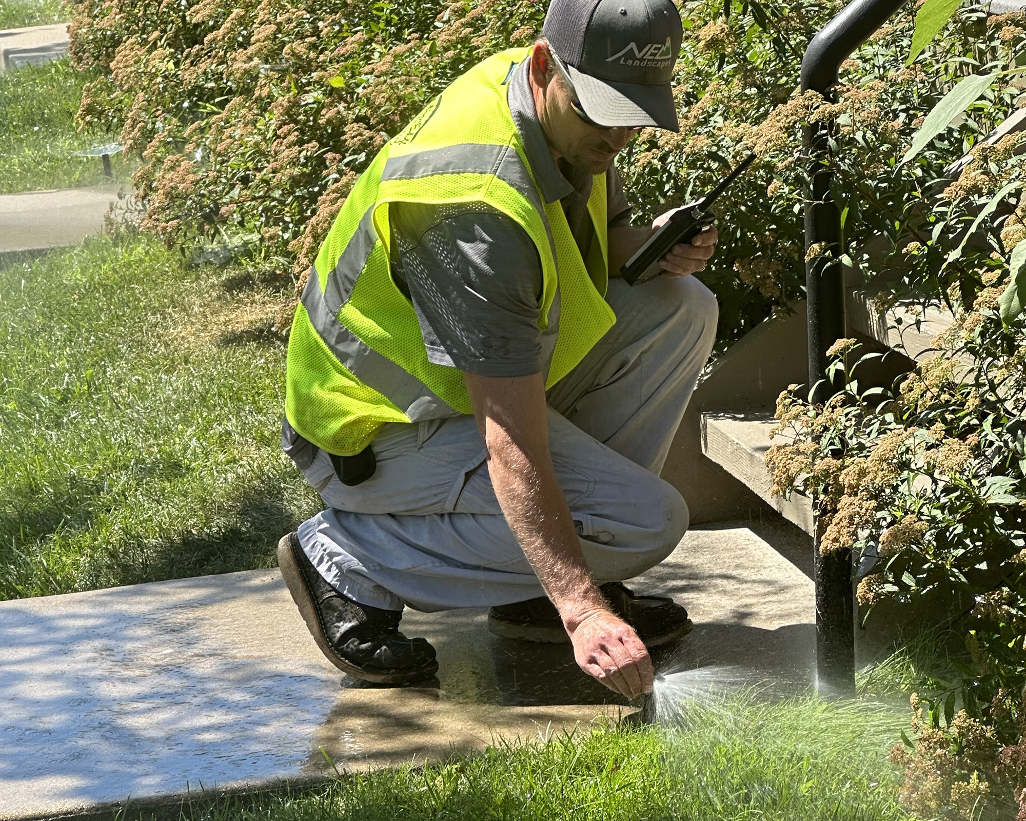 Irrigation technician adjusting a sprinkler head